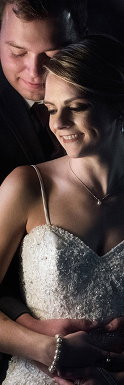 Married couple embracing, photographed by St. Louis wedding photographer Tracey Bartmann-Leek.
